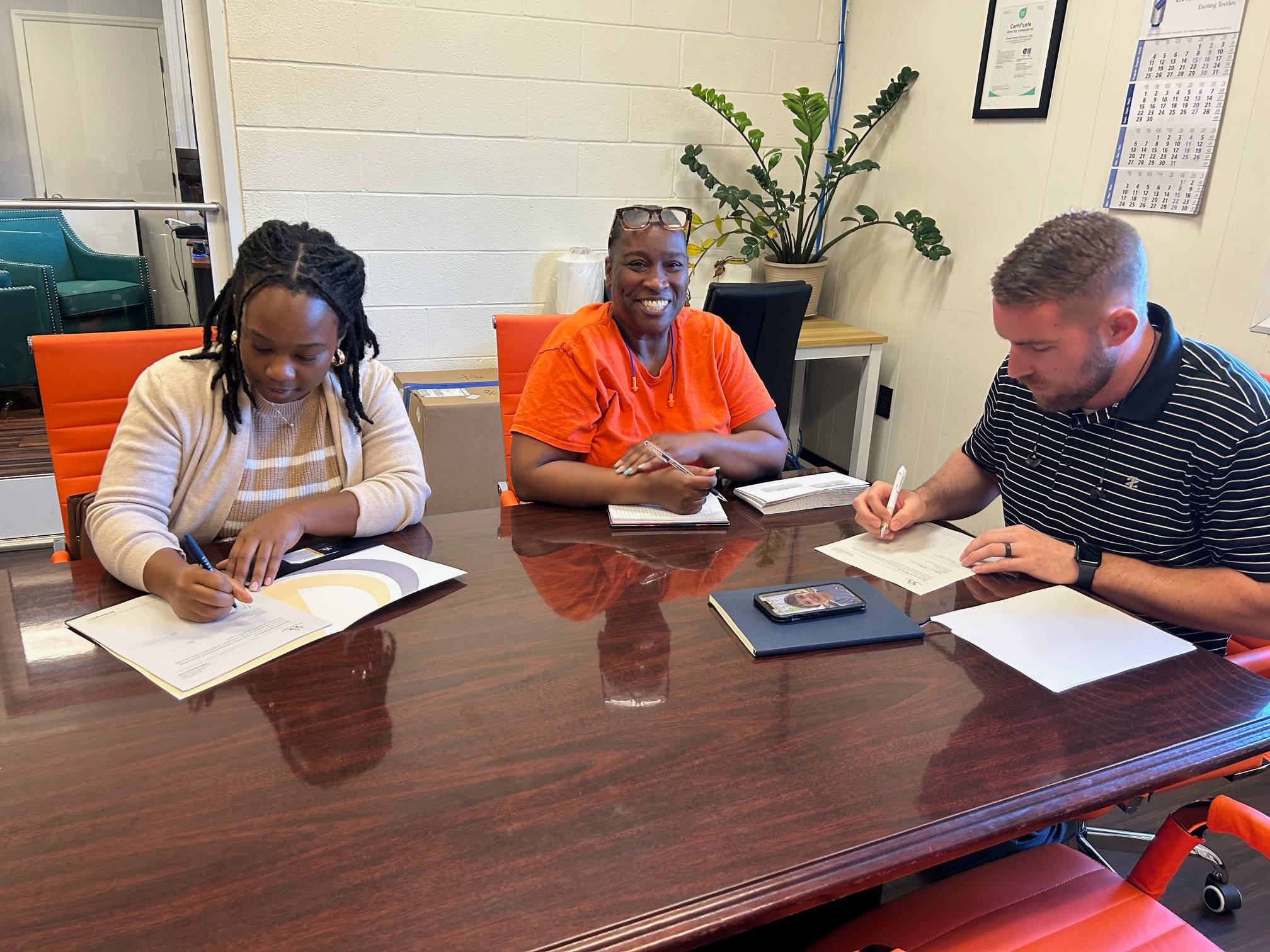 Tyshea Lewis, sigining agreement with Zimmermann-Dynayarn CEO Will McGowen