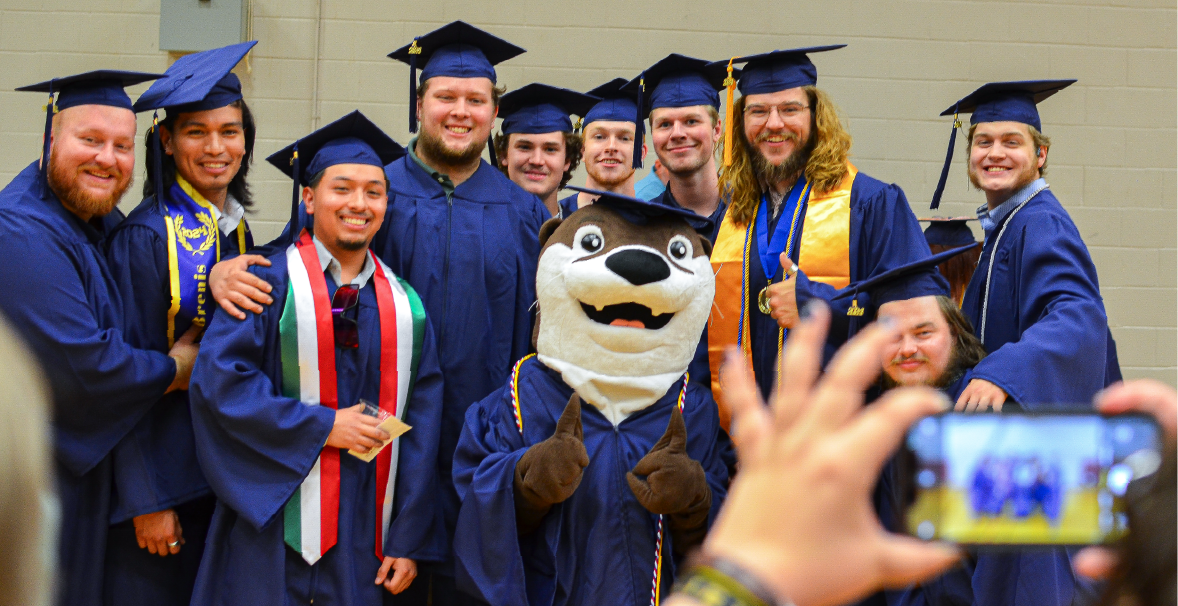 a group of acc graduates in blue graduation robes
